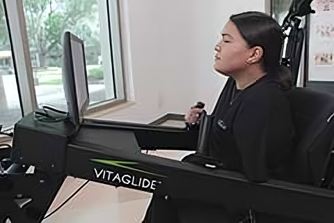 Person using Vitaglide exercise machine indoors.