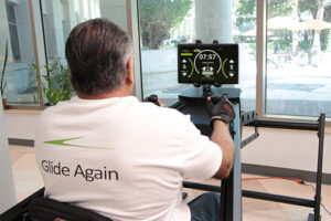 Man exercising on a rowing machine indoors.